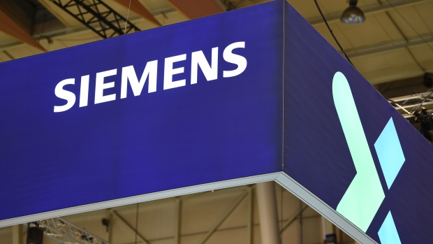 A logo above the Siemens AG booth on day two of the Web Summit in Lisbon, Portugal, on Thursday, Nov. 3, 2022. The Web Summit runs from 1-4 November. Photographer: Zed Jameson/Bloomberg