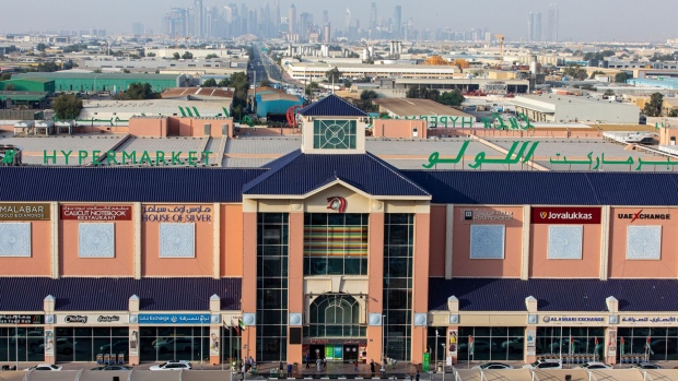 Skyscrapers stand on the city skyline beyond a Lulu hypermarket, operated by Lulu Group International, during the coronavirus lockdown in Dubai, United Arab Emirates, on Thursday, April 23, 2020. An investment firm backed by a member of Abu Dhabi’s royal family agreed to buy a stake worth just over $1 billion in LuLu Group International, which runs one of the Middle East’s largest hypermarket chains, according to people familiar with the matter.