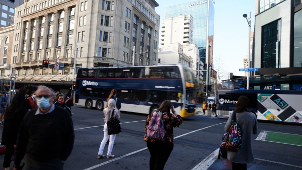 Commuters wait at a junction in Auckland, New Zealand, on Wednesday, Sept. 16, 2020. New Zealand’s economy will endure a shallower recession than previously expected but the coronavirus pandemic will have a longer impact on the country’s finances, according to government projections.