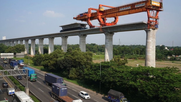 An under construction section of elevated track for the Jakarta-Bandung High-Speed Railway (HSR) runs next to a highway in West Java in 2021. Photographer: Dimas Ardian/Bloomberg