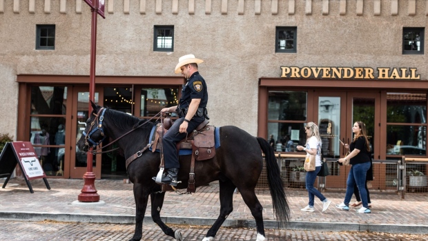 A Fort Worth Police Department officer patrols on a horse through the Fort Worth Stockyards. Photographer: Kathy Tran/Bloomberg