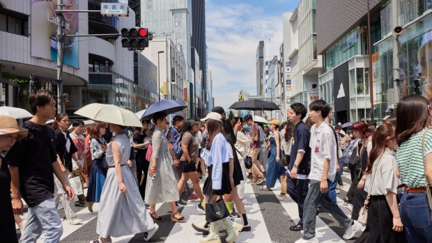 People cross a street in a shopping district in Tokyo, Japan, on Saturday, June 17, 2023. Japan is scheduled to announce its consumer price index figures on June 23. Photographer: Shoko Takayasu/Bloomberg
