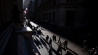 Pedestrians walk along Wall Street near the New York Stock Exchange (NYSE) in New York, U.S., on Monday, Oct. 31, 2016. U.S. stocks rose from a six-week low amid an increase in deal activity as traders assessed the outlook for the presidential election and interest rates in the world's largest economy. Photographer: Michael Nagle/Bloomberg