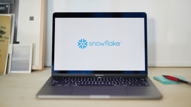Snowflake Inc. signage is displayed on a laptop computer in an arranged photograph taken in the Brooklyn borough of New York, U.S., on Wednesday, Sept. 16, 2020. Snowflake Inc. soared in a euphoric stock-market debut that transformed the eight-year-old software company into business valued at about $72 billion. Photographer: Gabby Jones/Bloomberg