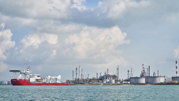 Oil Refineries and storage tanks standing at the Shell Eastern Petrochemicals Complex (SEPC) on Pulau Bukom are seen from a boat off the coast of Singapore, on Tuesday, May 25, 2020. The Singapore government expects gross domestic product to shrink 4% to 7% this year, down from a previous forecast of a 1%-4% contraction, as the outlook for external demand deteriorates, the Ministry of Trade and Industry said in a statement Tuesday. Photographer: Lauryn Ishak/Bloomberg