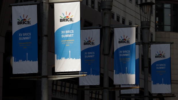 Event flags outside the venue for the BRICS summit at the Sandton Convention Center in the Sandton district of Johannesburg, South Africa, on Monday, Aug. 21, 2023. The summit of BRICS leaders is scheduled to take place from Aug. 22-24 in Johannesburg, where they’ll discuss whether to admit more nations to its ranks. Photographer: Michele Spatari/Bloomberg