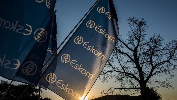 Company flags fly outside the Eskom Holdings SOC Ltd. Megawatt Park headquarters office in Johannesburg, South Africa, on Tuesday, July 30, 2019. Eskom reported a record loss of 20.7 billion rand.