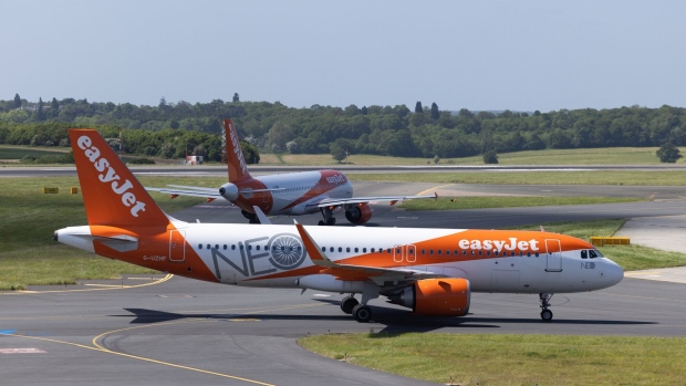 Passenger aircraft operated by EasyJet Plc, on the tarmac at London Luton Airport in Luton, UK, on Friday, May 26, 2023. Ticket prices across the industry have been edging higher, partly because of robust demand for summer getaways, and partly because of a scarcity of aircraft as airlines clamor to get hold of new models. Photographer: Chris Ratcliffe/Bloomberg