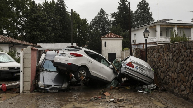  Cars piled up in a street following heavy rain in Villamanta, Madrid region, on Sept. 4. Photographer: Pablo Blazquez Dominguez/Getty Images Europe