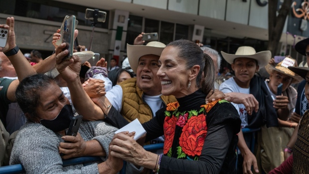 Claudia Sheinbaum, former mayor of Mexico City and primary candidate for the Morena party, center, greets supporters during a campaign rally in Mexico City, Mexico, on Saturday, Aug. 26, 2023.