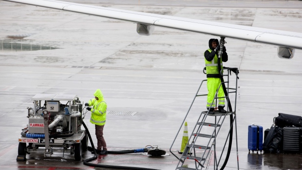 Ground operations employees fuel a Frontier Airlines Inc. plane on the tarmac at Denver International Airport (DIA) in Denver, Colorado, U.S., on Tuesday, April 4, 2017. Frontier Airlines Inc., the no-frills U.S. carrier whose aircraft feature animals on the tails, is aiming to go public as soon as the second quarter, people with knowledge of the matter said.