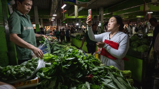 A customer scans a QR code to purchase vegetables at a wet market in Beijing, China, on Thursday, Sept. 7, 2023. China is scheduled to release consumer price index on Sept. 9.