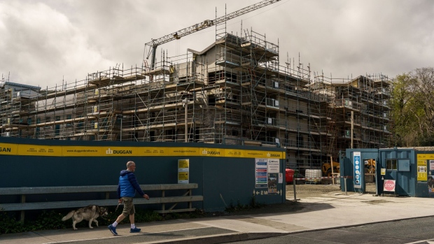 A pedestrian passes a residential construction site in the Sandyford district of Dublin, Ireland, on Monday, May 10, 2021.  Photographer: Paulo Nunes dos Santos/Bloomberg