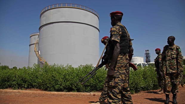 South Sudanese soldiers stand during President Salva Kiir's visit to an oil refinery in Melut, Upper Nile State, South Sudan on Nov. 20, 2012.