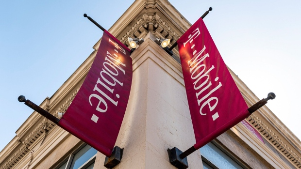 Signage for a T-Mobile store in San Francisco, California, U.S., on Tuesday, March 16, 2021. T-Mobile US Inc. is kicking off a bond sale to help finance the purchase of new high-speed spectrum licenses as carriers roll out the next generation of mobile devices.