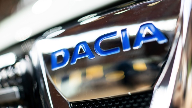 A logo on a Dacia Spring crossover electric automobile, manufactured by Renault SA, is displayed on a vehicle during the automaker's E-Ways event in Paris, France, on Friday, Oct. 16, 2020. Renault SA’s promotional blitz for its growing electric lineup may be too late for the maker of Europe’s best-selling EV to stay atop the region’s expanding market for battery-powered cars. Photographer: Benjamin Girette/Bloomberg