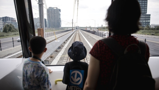 Visitors ride the Reseau Express Metropolitain light rail during its inauguration ceremony in Montreal in July.