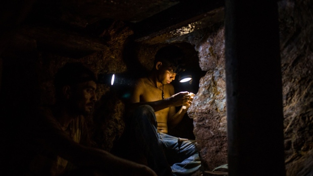 Miners work inside an underground mine in El Callao, Bolivar State, Venezuela, on Tuesday, Feb. 27, 2018. The military has been fighting for months to master El Callao, the dangerous nation's most dangerous town, and a beachhead in efforts to develop a mineral-rich region the government calls the Arco Minero del Orinoco. Photographer: Manaure Quintero/Bloomberg