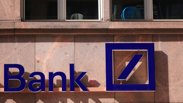 A logo outside a Deutsche Bank AG bank branch in Berlin, Germany, on Monday, March 27, 2023. Deutsche Bank AG shares rebounded and the cost of insuring its debt against default eased on Monday after sell-side analysts sought to reassure that the German lender’s financial health was sound. Photographer: Krisztian Bocsi/Bloomberg
