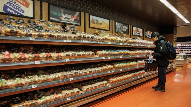 A shopper in the bread aisle at a grocery store in Toronto. Food inflation was 7.8%