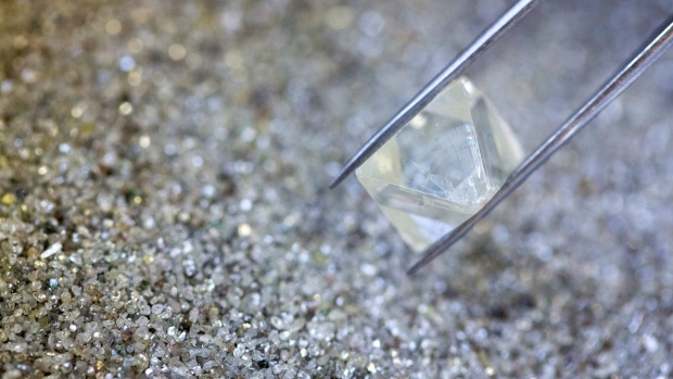 An employee sorts through a large collection of rough diamonds on a sorting table at the United Selling Organisation (USO) of Alrosa PJSC sorting center in Moscow, Russia, on Tuesday, Feb. 12, 2019. Alrosa PJSC, one of the world’s top diamond miners, is returning to crisis-stricken Zimbabwe, the latest example of Russia expanding its footprint in Africa. Photographer: Andrey Rudakov/Bloomberg