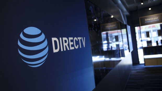 AT&T Inc. and DirecTV signage is displayed at a store in Newport Beach, California, U.S., on Thursday, Aug. 10, 2017. AT&T Inc. shares surged the most in more than eight years after the telecommunications giant posted a surprise wireless subscriber gain in the second quarter, showing it can fend for itself in a cutthroat price war. An offer for unlimited wireless data, bundled with discounted streaming-TV service, helping AT&T bide its time while awaiting regulatory approval to transform into a media powerhouse through the $85.4 billion purchase of Time Warner Inc. Photographer: Patrick T. Fallon/Bloomberg