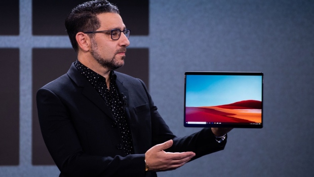 ]Panos Panay, chief product officer of Microsoft Corp., displays the Surface Pro X hybrid tablet and laptop computer during a Microsoft product event in New York, U.S., on Wednesday, Oct. 2, 2019. Microsoft unveiled a dual-screen, foldable phone that will run on Google's Android operating system, jumping back into a market it exited years ago.