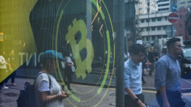 The logo for Bitcoin on a screen in Hong Kong, China, on Wednesday, May 24, 2023. Hong Kong, which is preparing to introduce a new regime for trading digital assets, is responding to concerns raised by industry players about the shortage of a crucial type of worker. Photographer: Paul Yeung/Bloomberg