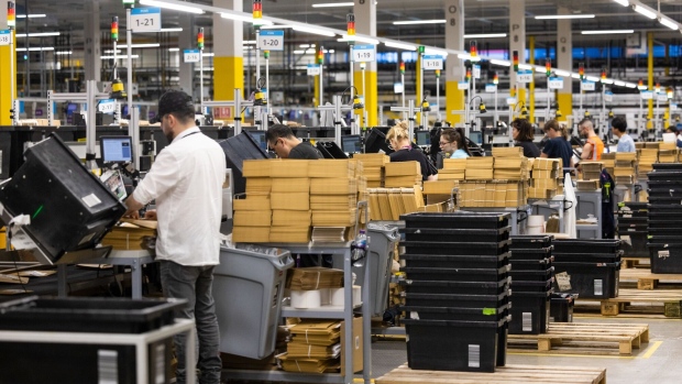 Employees pack items in to boxes at the Amazon.com Inc. LCY3 fulfillment center in Dartford, UK, on Friday, July 7, 2023. Amazon launched Prime Day in 2015 to attract new subscribers who now pay $139 a year for shipping discounts, video streaming and other perks.