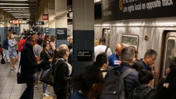 Commuters at the Times Square subway station in New York, US, on Friday, May 19, 2023. New York City Transit reported 12.4 million people entered the subway during the last work week, down 1.5% from the previous week.