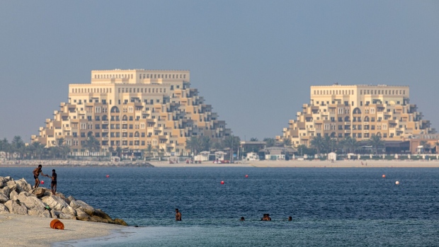 Beachgoers swim in front of the Rixos Bab Al Bahr hotel on Al Marjan Island in Ras Al Khaimah, United Arab Emirates, on Sunday, June 25, 2023. Ras Al Khaimah — RAK for short — is pursuing an ambitious foreign direct investment strategy that’s luring five-star hotels, industrialists and adventure-seeking tourists from countries ranging from Russia to the Czech Republic.
