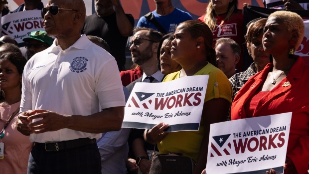 New York Mayor Eric Adams (left) attends a rally calling for expedited federal work authorization for asylum seekers on Aug. 31.