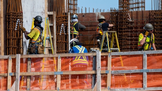 Workers on a condo building under construction. Photographer: James MacDonald/Bloomberg