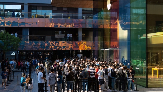 Customers queue outside an Apple store in Beijing.
