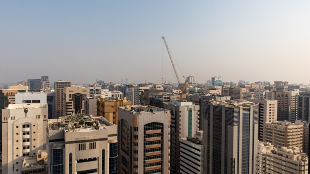 A construction crane stands among commercial and residential properties in the Al Zahiyah neighbourhood of Abu Dhabi, United Arab Emirates, on Wednesday, Oct. 2, 2019. Abu Dhabi sold $10 billion of bonds in a three-part deal in its first international offering in two years as it takes advantage of relatively low borrowing costs.