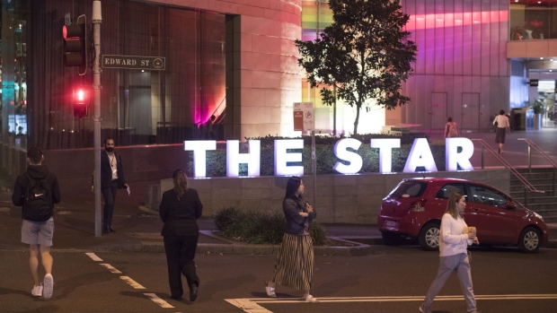 Pedestrians cross a street outside the Star complex, operated by Star Entertainment Group Ltd., in Sydney, Australia, on Tuesday, March 15, 2022. Star is optimistic business at its Australian casinos will soon return to pre-pandemic levels as the remaining Covid restrictions are eased and international tourists return.