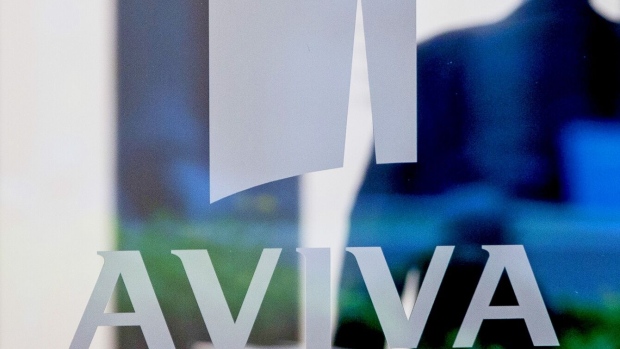 An Aviva Plc logo sits on a window at St Helen's, the commercial skyscraper housing the insurance company's headquarters in London, U.K., on Monday, Aug. 1, 2016. Aviva will release their half-year results on Aug 4. Photographer: Bloomberg/Bloomberg