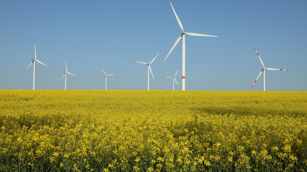PINNOW, GERMANY - MAY 10: Wind turbines spin over a field of canola, also called rapeseed, at a wind park on May 10, 2023 near Pinnow, Germany. The German government is seeking a rapid expansion of Germany's renewable energy production capacity, with wind and photovoltaic as the favoured technologies. (Photo by Sean Gallup/Getty Images)