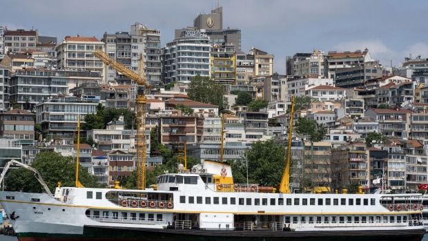 A ferry moored beside business and residential apartments in Istanbul, Turkey, on Thursday, June 8, 2023. Turkey's lira plunged to a record low as state-run lenders temporarily halted dollar sales, in a sign the new economic team is abandoning a costly intervention strategy as part of an expected turn toward more conventional policies.