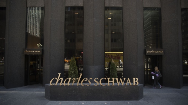 A person enters a Charles Schwab Corp. office building in New York, U.S., on Friday April 14, 2017. Charles Schwab Corp. is scheduled to release earning figures on April 18.