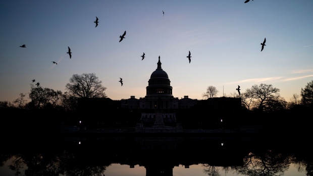Birds fly near the U.S. Capitol in Washington, D.C., U.S., on Thursday, Dec. 9, 2021. At the end of the month, the government's temporary moratorium on federal student loan payments expires, meaning loans will once again accrue interest and borrowers will be expected to resume monthly payments.