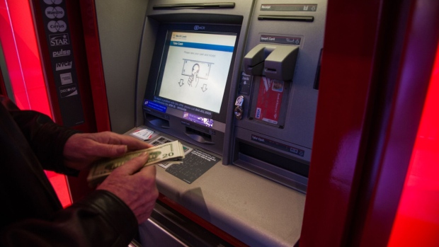 A customer withdraws money from an automatic teller machines (ATM) inside a Bank of America Corp. branch in New York, U.S., on Saturday, Jan. 13, 2018. Bank of America Corp. is scheduled to release earnings figures on January 17.