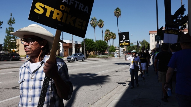 BURBANK, CALIFORNIA - SEPTEMBER 26: Striking SAG-AFTRA members picket outside Warner Bros. Studio as the actors strike continues on September 26, 2023 in Burbank, California. Hollywood is awaiting the final vote on a tentative contract agreement between over 11,000 Writers Guild of America (WGA) members and Hollywood studios in the nearly 150-day writers strike. (Photo by Mario Tama/Getty Images)