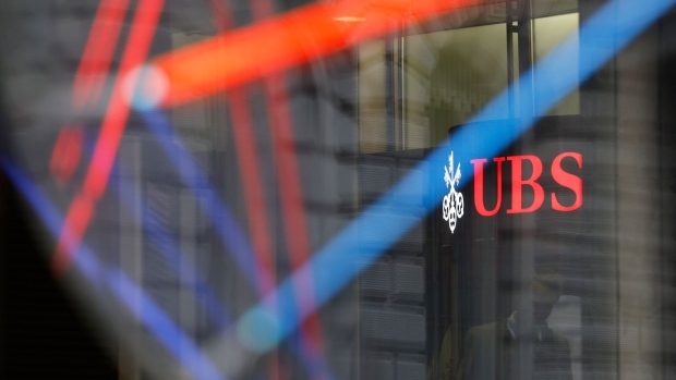 A logo outside the UBS Group AG headquarters in Zurich, Switzerland, on Tuesday, April 25, 2023. UBS attracted $28 billion from wealthy clients in the months running up to its takeover of Credit Suisse Group AG, in an early indication of how many assets the combined firms will be able to retain. Photographer: Stefan Wermuth/Bloomberg