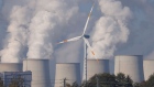 HEINERSBRUECK, GERMANY - OCTOBER 29: A wind turbine spins as steam rises from cooling towers of the Jaenschwalde lignite coal-fired power plant, which is among the biggest single emitters of CO2 in Europe, on October 29, 2021near Heinersbrueck, Germany. While Germany has invested heavily in renewable energy sources, including solar and wind power, over the past decades, it remains dependent on lignite coal for a significant portion of its energy production. And while other countries within the European Union have promised to phase out coal for electricity production within coming years, Germany has made its phase-out pledge for 2038. The COP26 2021 United Nations Climate Change Conference is to begin this coming Sunday in Glasgow. (Photo by Sean Gallup/Getty Images)