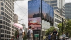 A public screen displays an image of the Shanghai city skyline in Shanghai, China, on Wednesday, Aug. 18, 2021. President Xi Jinping said China must pursue "common prosperity," in which wealth is shared by all people, as a key feature of a modern economy, while also curbing financial risks. Photographer: Qilai Shen/Bloomberg