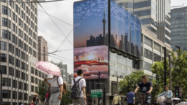 A public screen displays an image of the Shanghai city skyline in Shanghai, China, on Wednesday, Aug. 18, 2021. President Xi Jinping said China must pursue "common prosperity," in which wealth is shared by all people, as a key feature of a modern economy, while also curbing financial risks. Photographer: Qilai Shen/Bloomberg