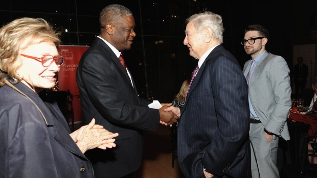 Dr. Denis Mukwege and George Soros greet each other as Alex Soros looks on in April 2015 in New York City.
