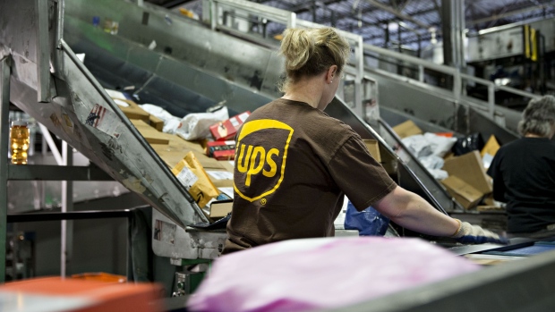 An employee sorts packages at the United Parcel Service Inc. (UPS) Chicago Area Consolidation Hub in Hodgkins, Illinois, U.S., on Tuesday, Dec. 5, 2017. UPS is expecting slight delays in package deliveries through the middle of this week after a surge in e-commerce sales swamped its network in the days after Thanksgiving.