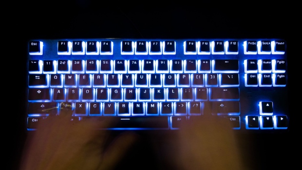 A man typing on a back lit computer keyboard. Photographer: Bloomberg Creative Photos/Bloomberg Creative Collection